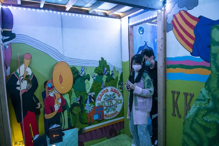 Woman entering a Beatles themed room