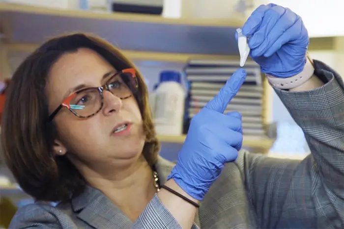 Whitehead looks at a vial