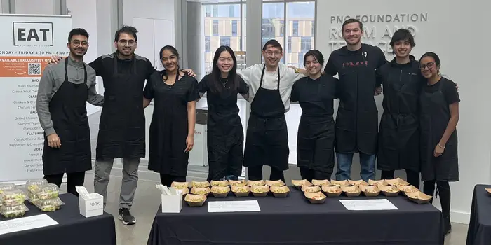 Capital Grains team standing behind tables at sampling event