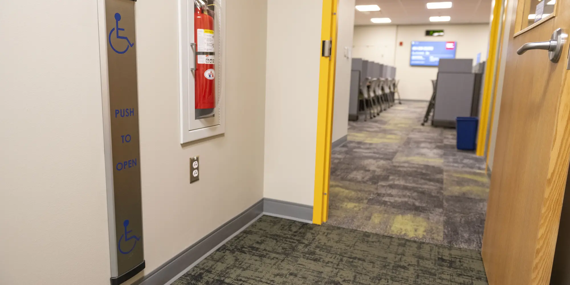 Open doorway into testing center showing automated door opener on left