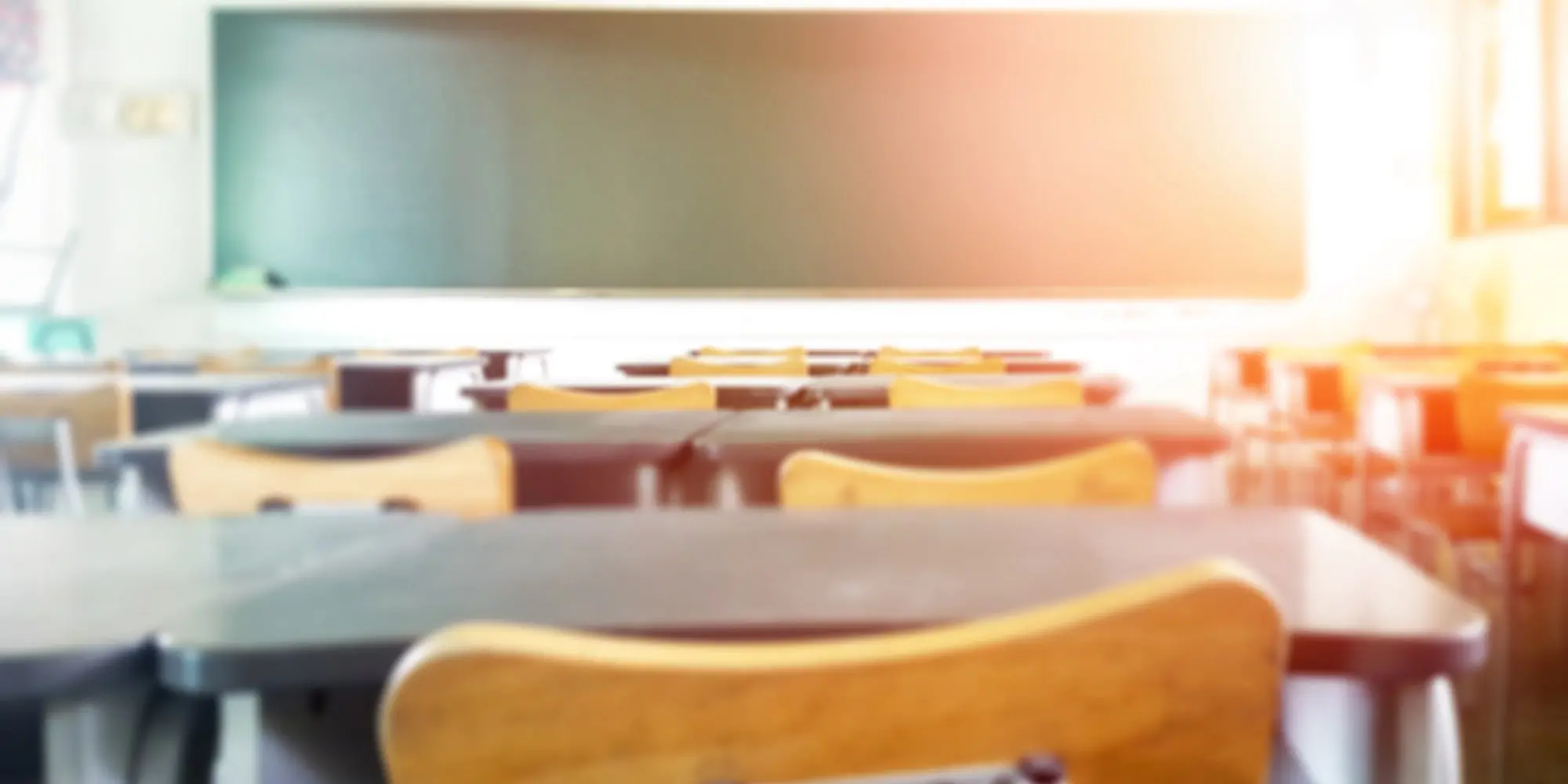 view of front of classroom from behind desks and chairs