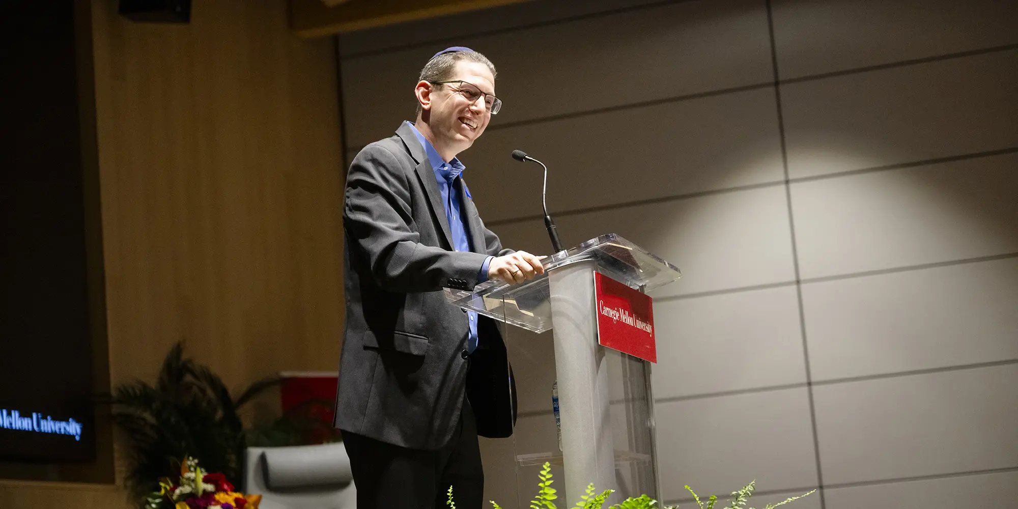 rabbi charlie cytron-walker standing at podium