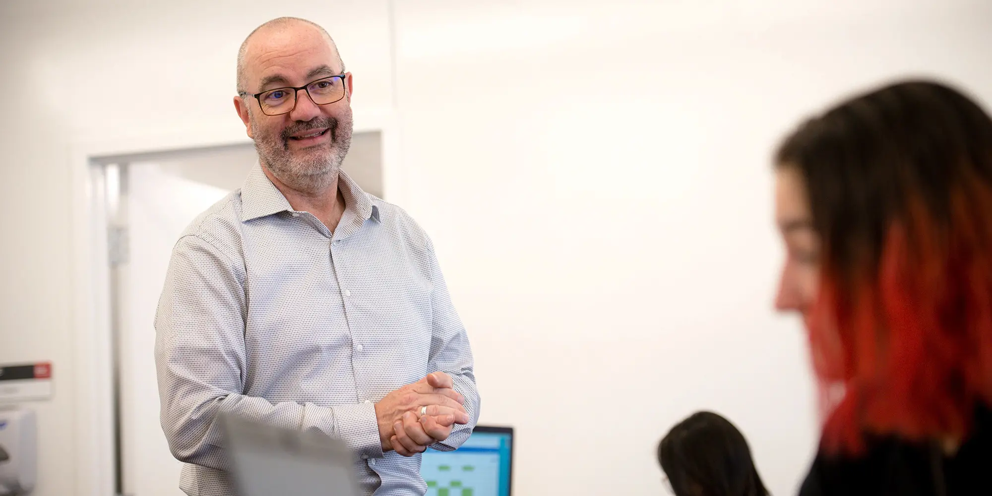 professor standing in classroom across from student