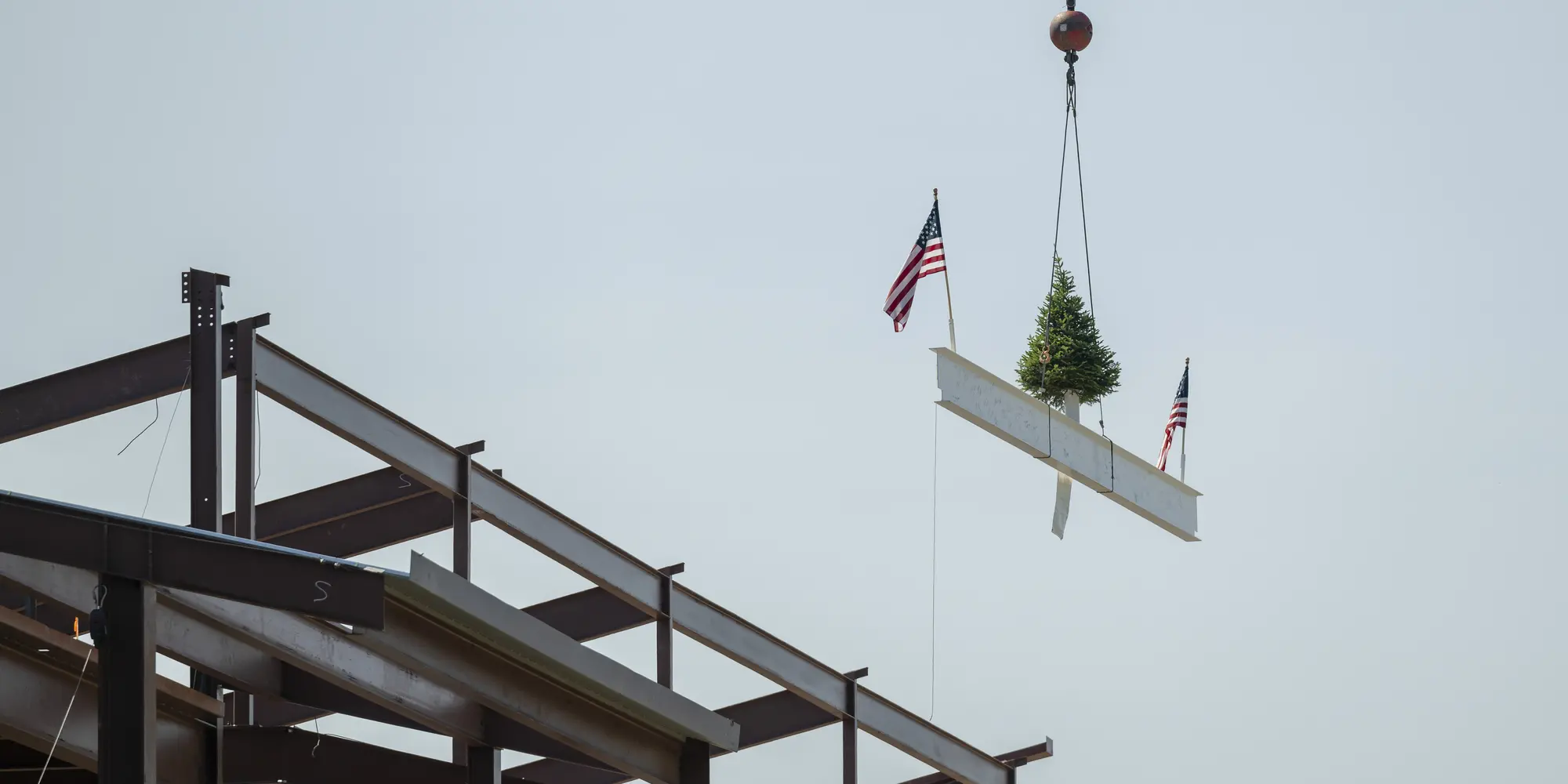 The final beam is hoisted to the top of the Robotics Innovation Center.