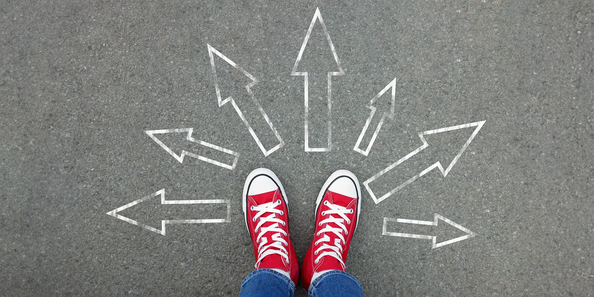 Shoes in a circle of outward-pointing arrows in chalk.