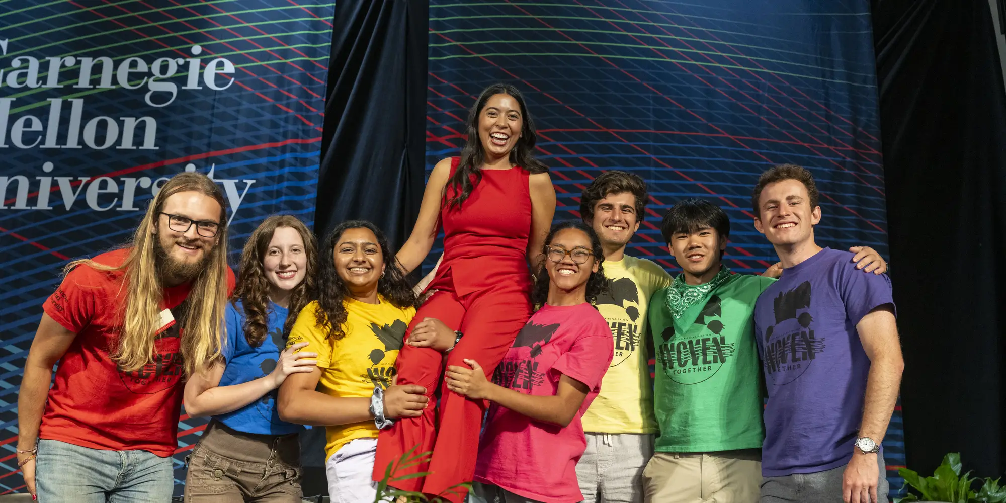 Orientation counselors pose for a group photo, lifting up fellow head counselor and event emcee Elizabeth Zapanta.