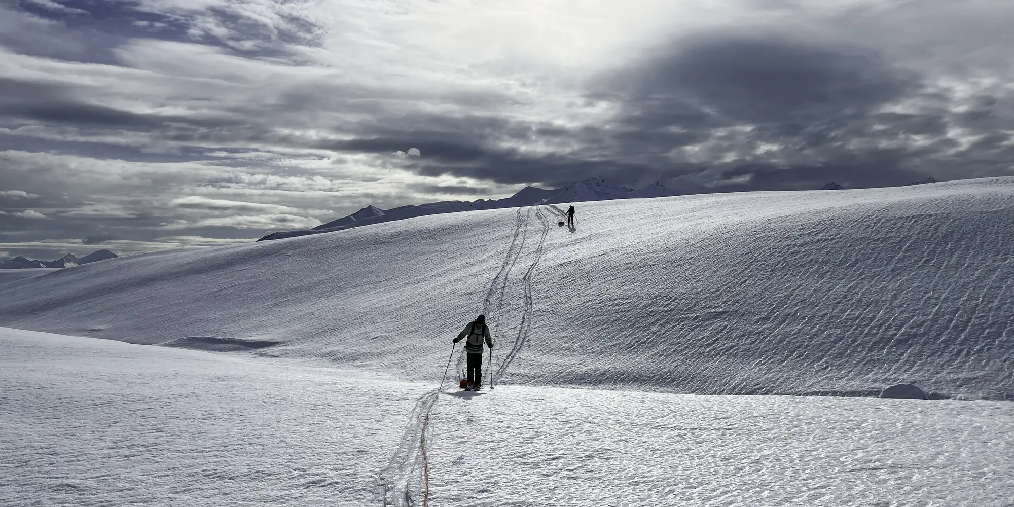 Two researchers trek across a glacier in Alaska.