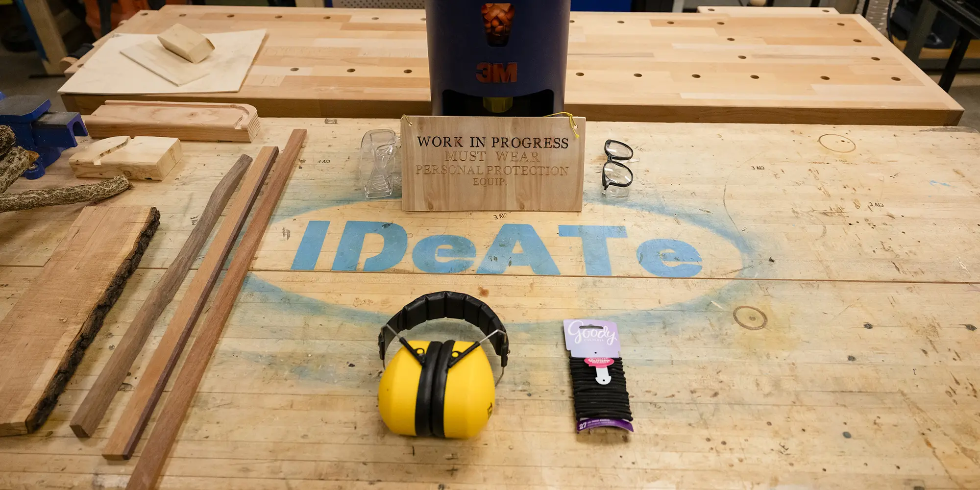 IDeATe painted in blue letters on wood