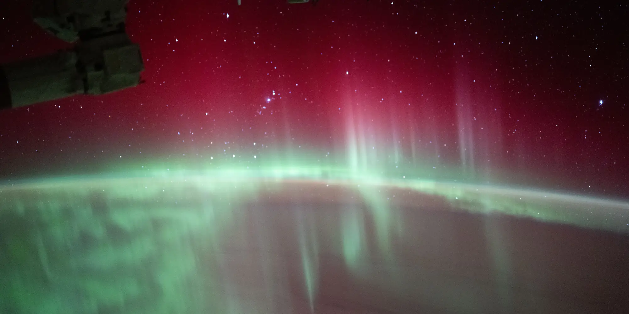 Stars glitter above green and red auroras swirling through Earth's atmosphere in this long-exposure shot taken on Aug. 11, 2024 from the International Space Station as it orbited 268 miles above the Indian Ocean. Image source: NASA