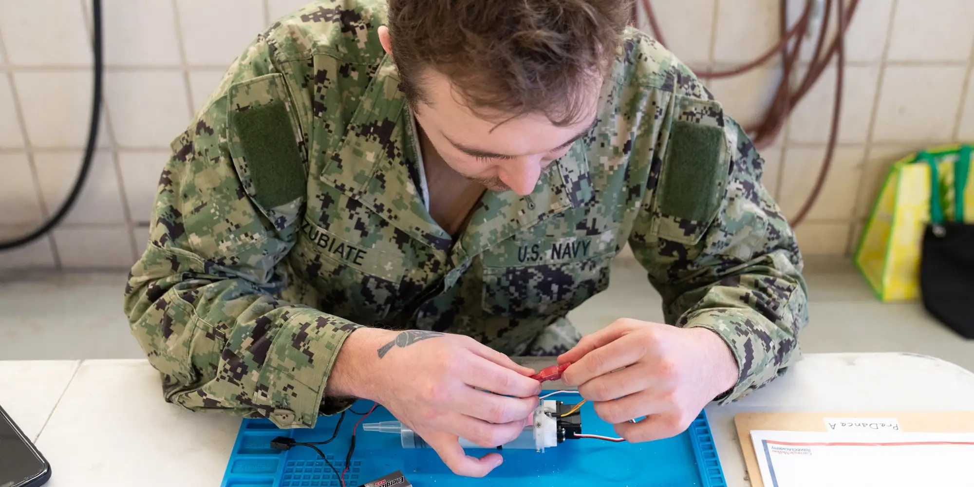 A sailor participates in a multi-event robotics field competition