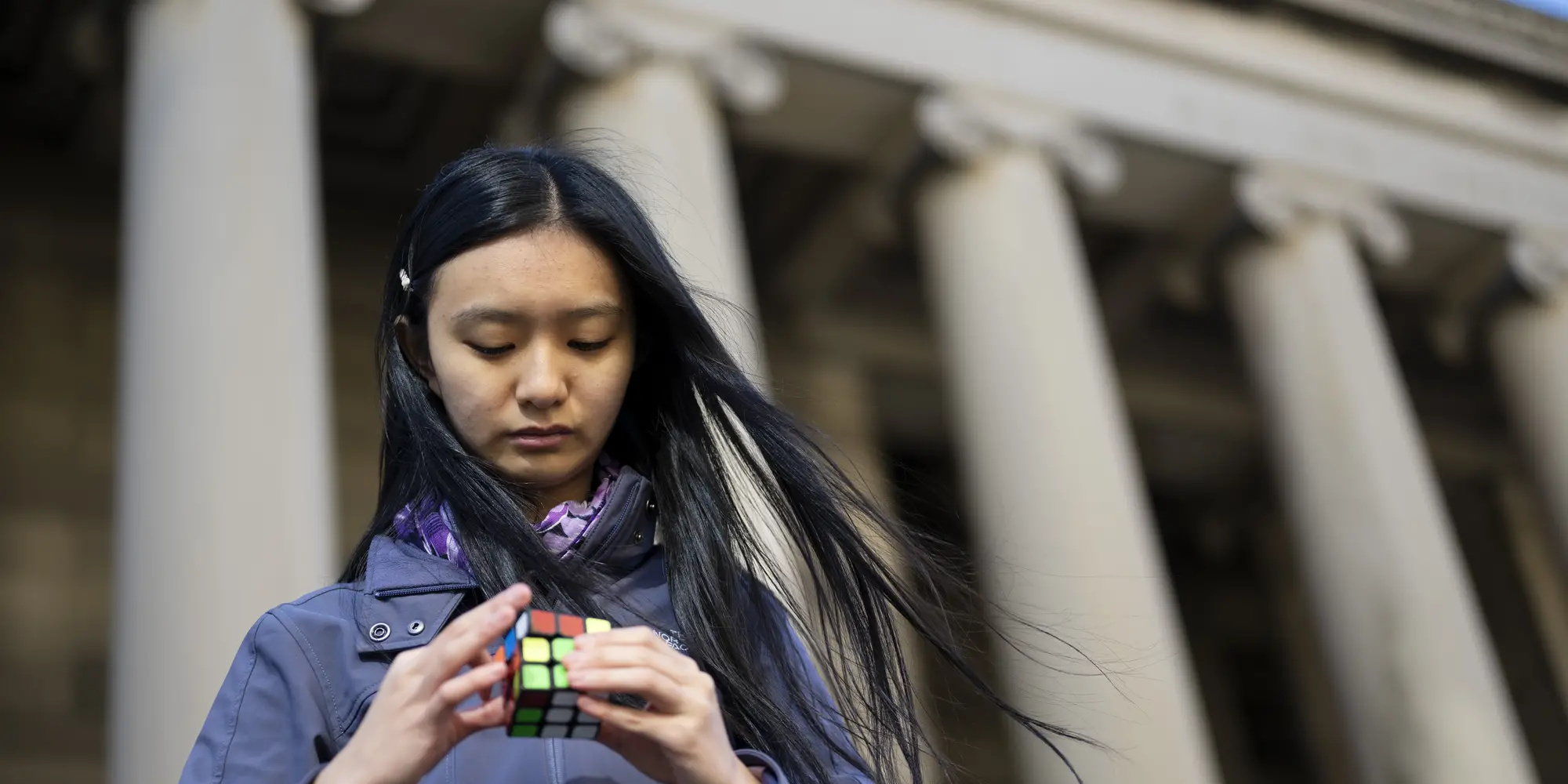 Jenny Quan uses a Rubik's cube.