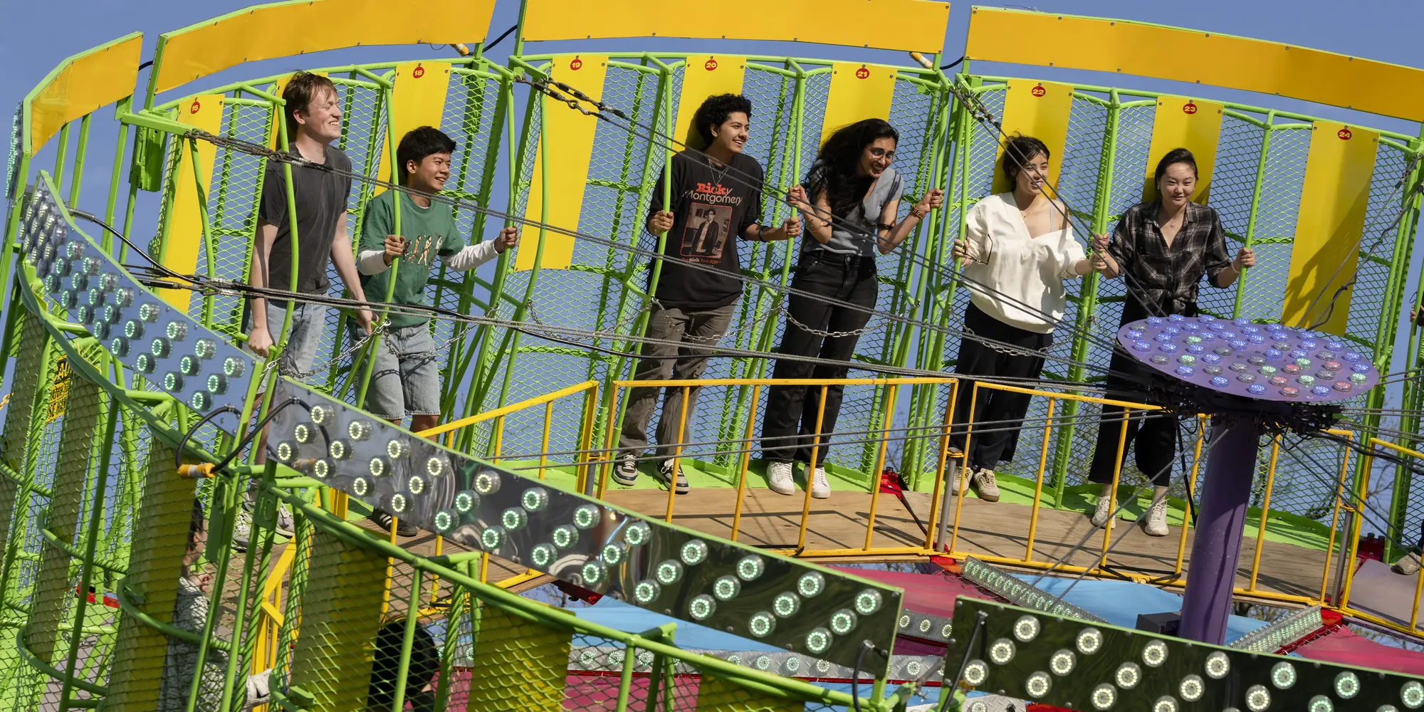 Students ride on a spinning carnival ride at CMU's Carnival. 