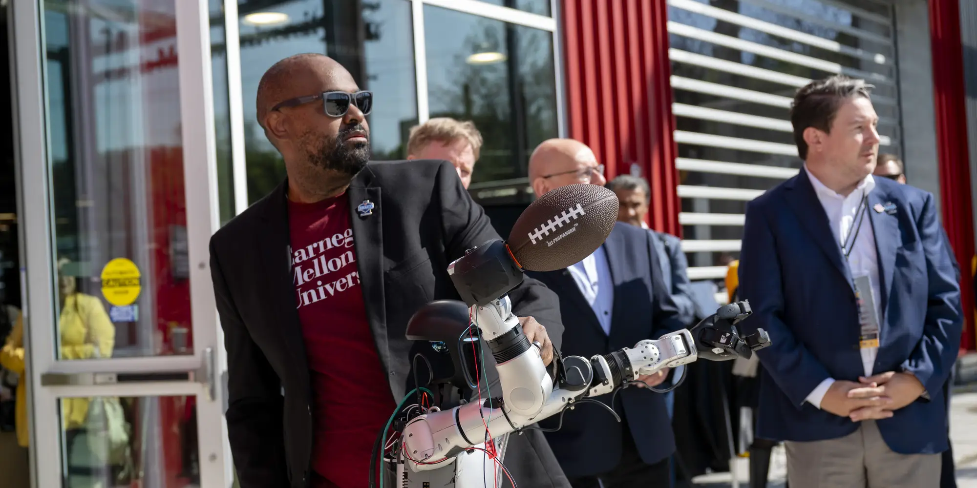 ETC director Derek Ham shows off a robot that can throw a football. 