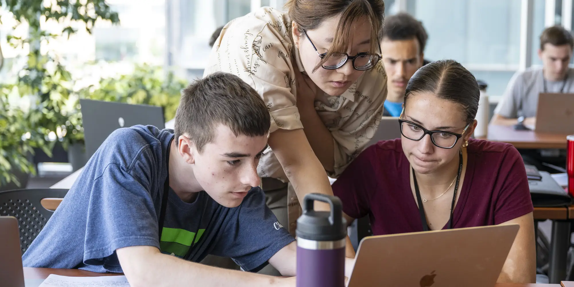 Students receive guidance from an instructor.