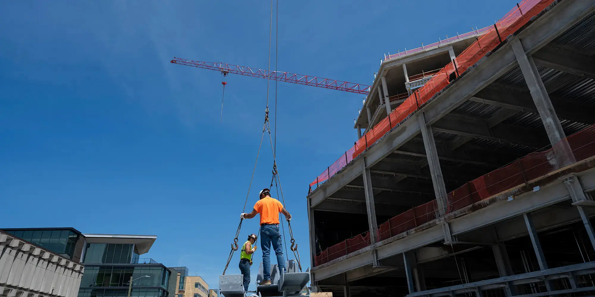 The last steel beam of the Richard King Mellon building is hoisted into place, “topping off” the facility’s structural phase.