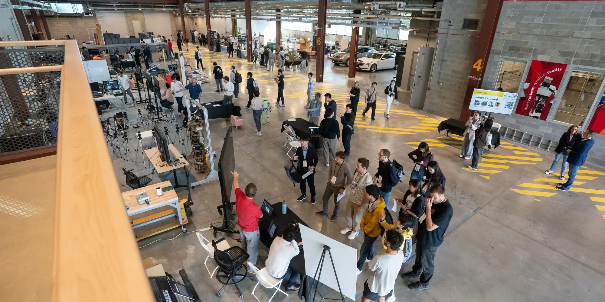 Attendees brows demo booths in the Robotics Innovation Center as part of the 2026 IROS conference..