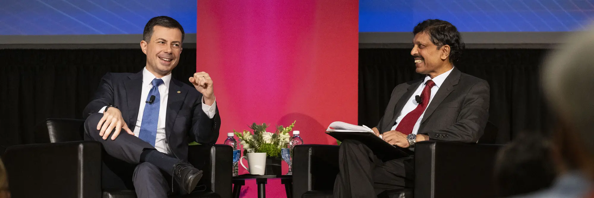 Pete Buttigieg and Raj Rajkumar talk during a Q&A.