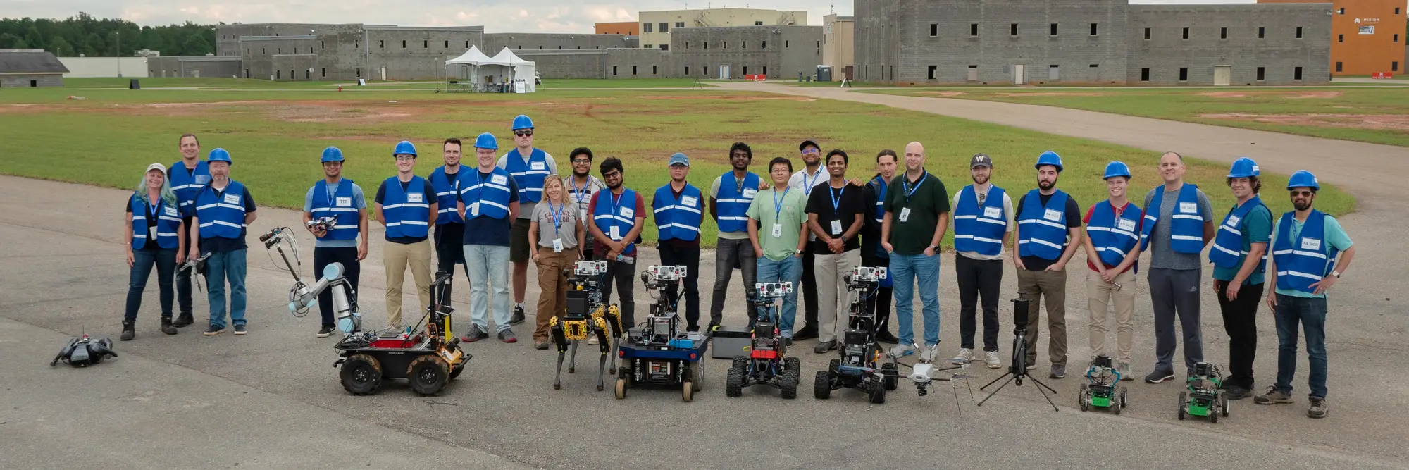 Team Chiron in a field with robots. 