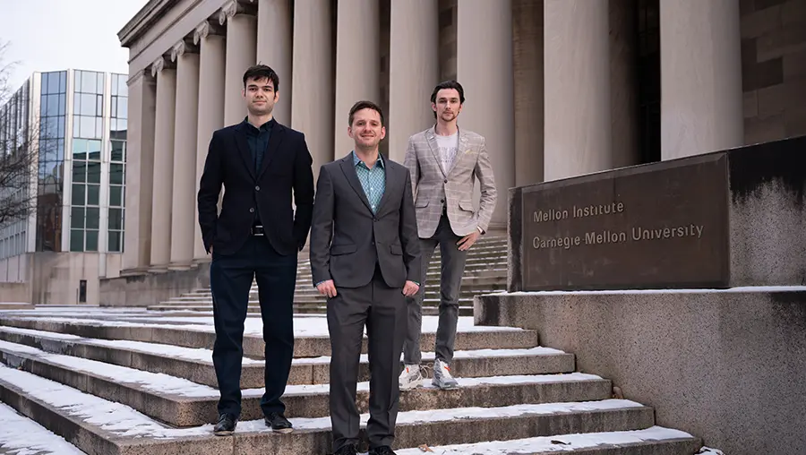 three men standing on steps of Mellon Institute