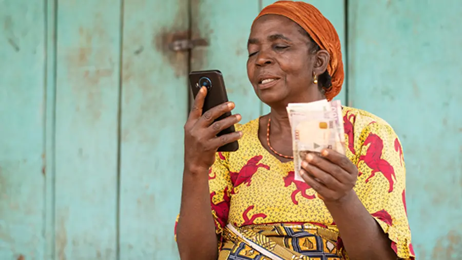 A woman looking at a cell phone.