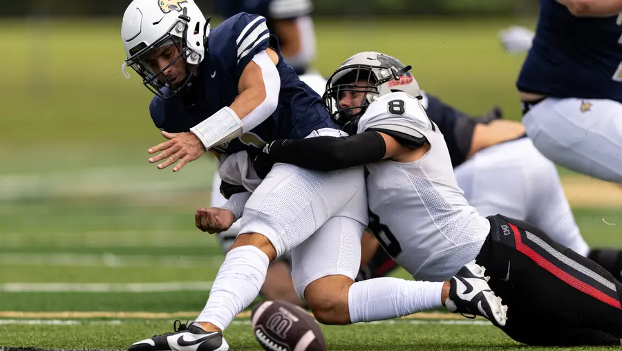 Robert Coury tackles a player.