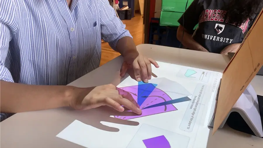 hands on table making origami