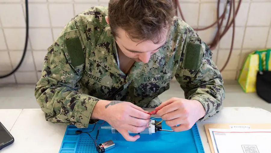 A sailor participates in a multi-event robotics field competition
