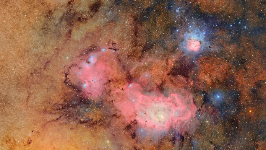 This image combines 678 separate images taken by NSF-DOE Vera C. Rubin Observatory in just over seven hours of observing time. Combining many images in this way clearly reveals otherwise faint or invisible details, such as the clouds of gas and dust that comprise the Trifid nebula (top right) and the Lagoon nebula, which are several thousand light-years away from Earth.