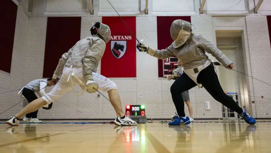 Two people fencing.