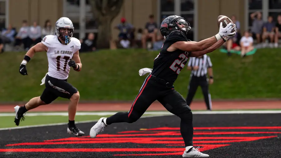 A CMU football player extends for a catch in the end zone. 