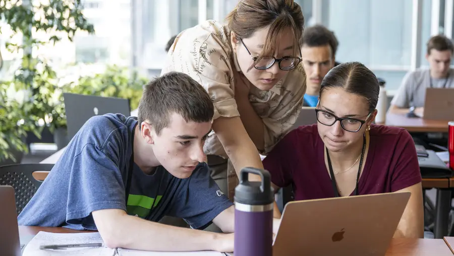 Students receive guidance from an instructor.