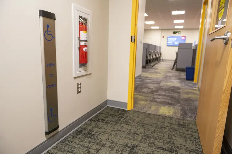 Open doorway into testing center showing automated door opener on left