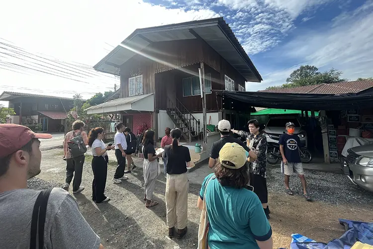 students standing outside observing a building