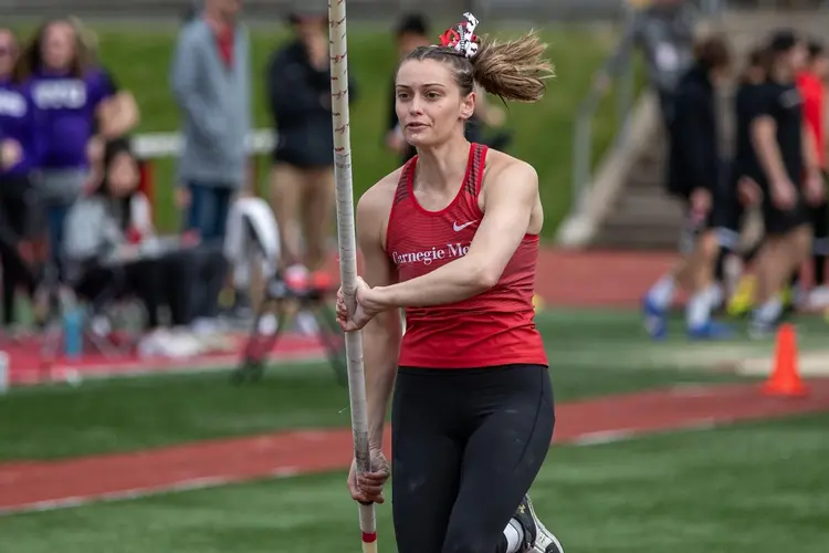 JoJo Huczko running with pole on field