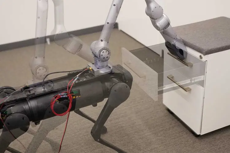 A robot opens a drawer.