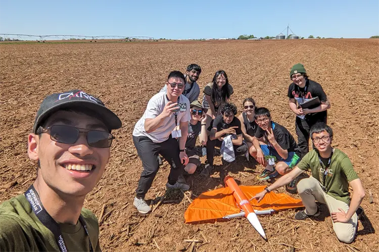 students take selfie with rocket
