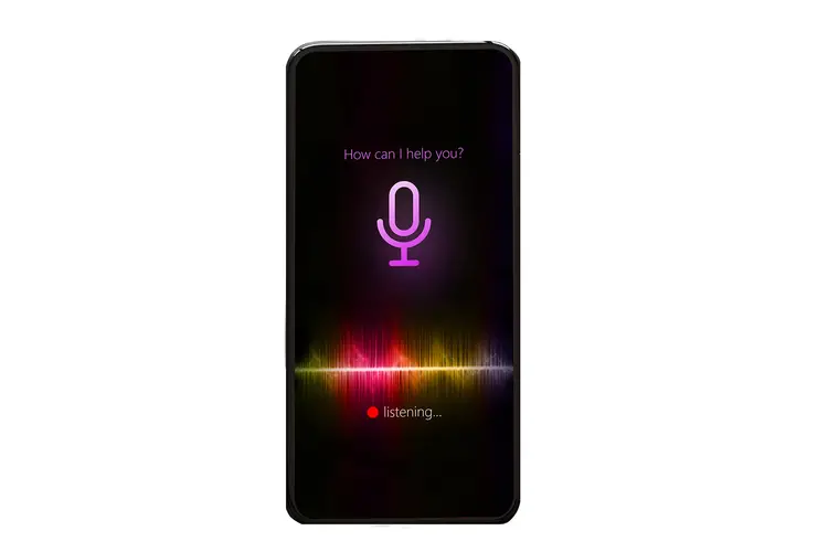 A cell phone using a voice assistant with the text "how may I help you?"