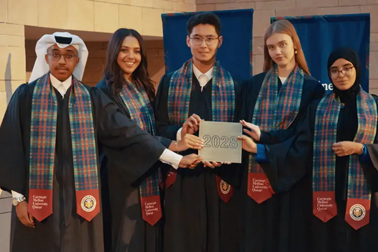 Representatives from the Class of 2028 receive the class tile at the First-Year Convocation.