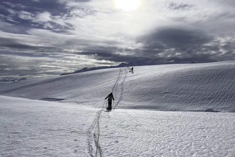 Two researchers trek across a glacier in Alaska.