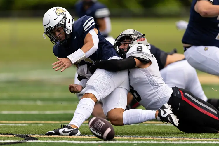 Robert Coury tackles a player.