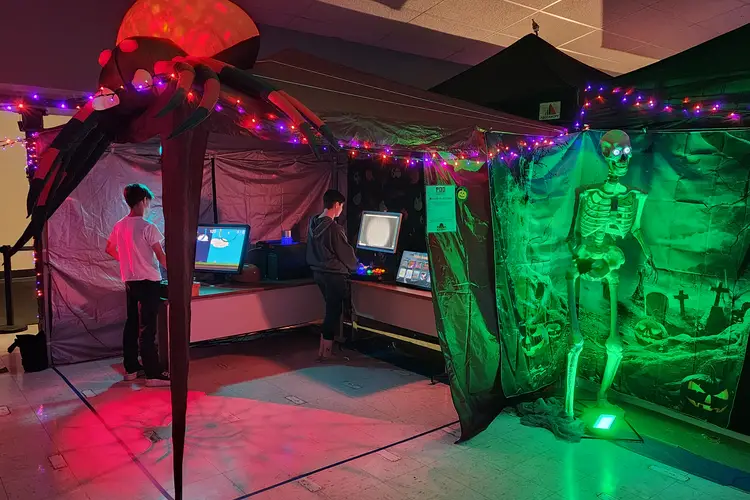 A crew works to build attractions at a Halloween festival.