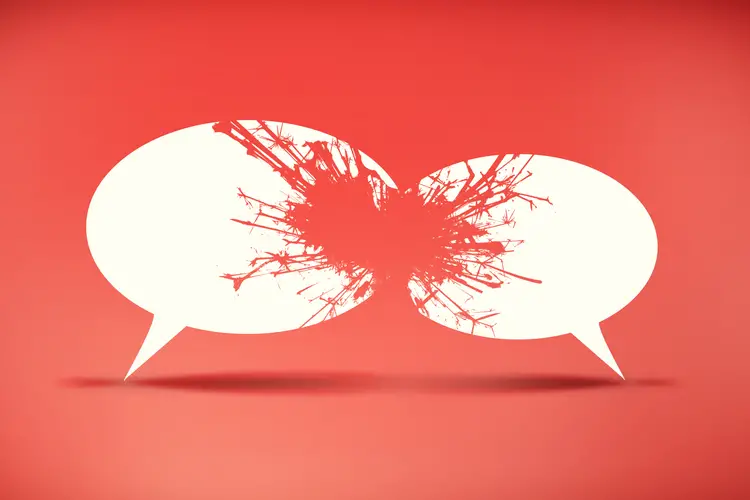 Two cartoon speech bubbles clash as if to shatter against a red background