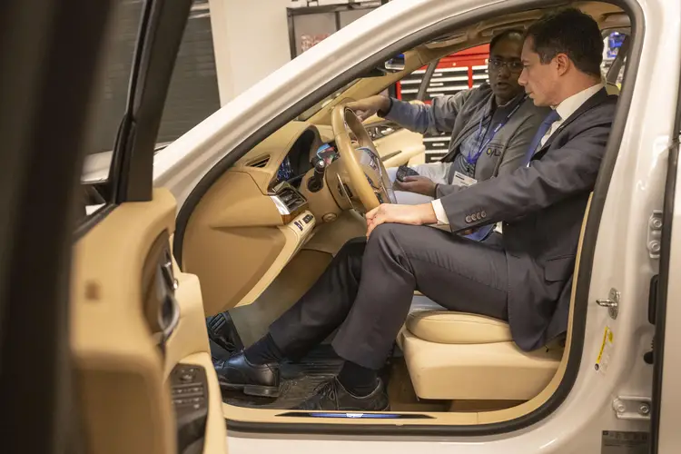 Nishad Sahu, Ph.D. candidate in Electrical and Computer Engineering, explains the features of an autonomous Cadillac CT6 to U.S. Secretary of Transportation Pete Buttigieg