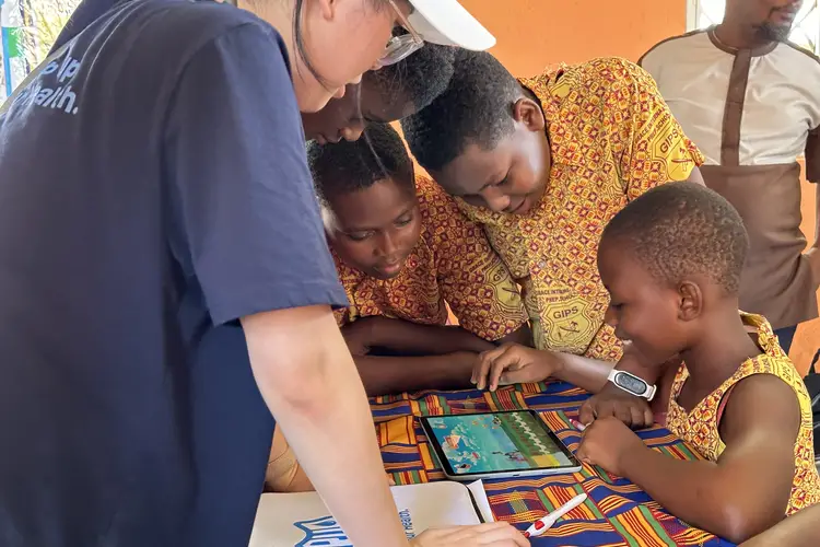 Students in Ghana use a tablet. 