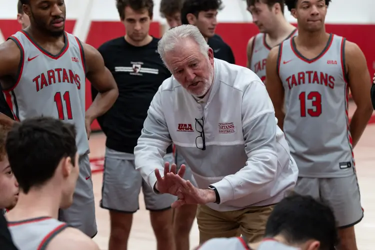 Tony Wingen, head Men’s basketball coach, talks to his team during a timeout. 