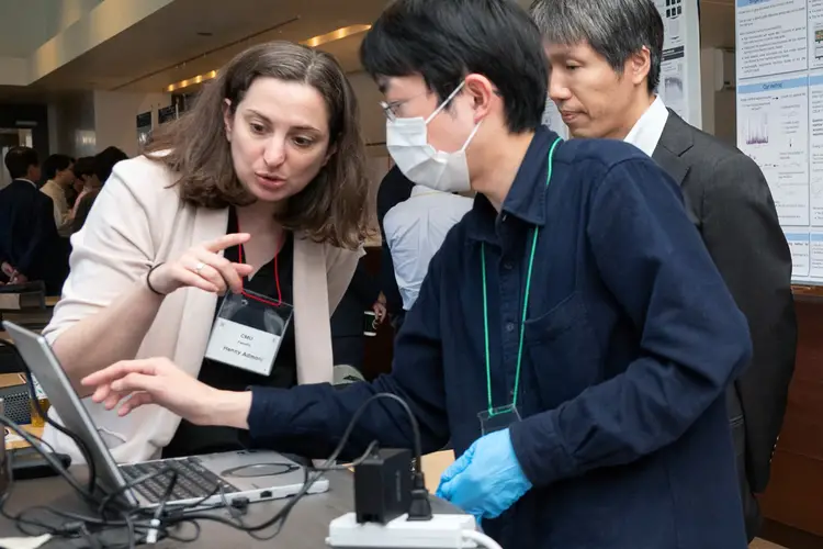 CMU's Henny Admoni speaks to two people at a poster session.