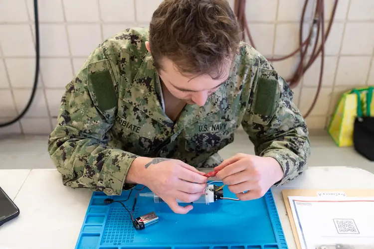 A sailor participates in a multi-event robotics field competition