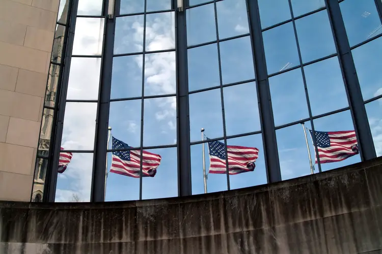 Exterior photo of the SEI building with four American flags