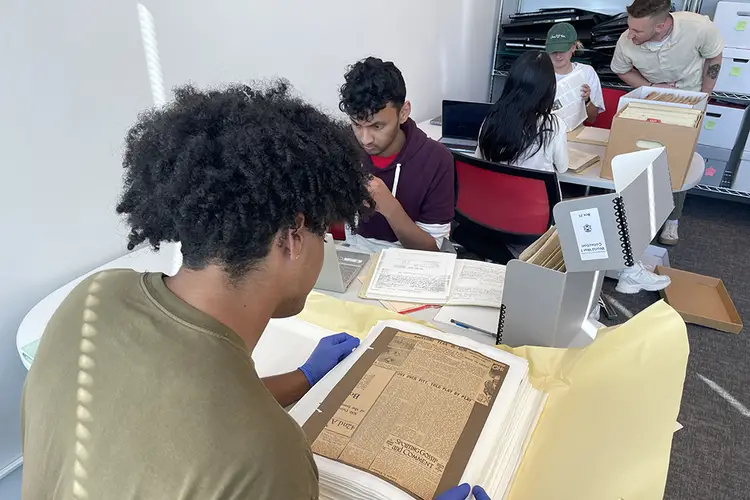 Students look through CMU archival material.