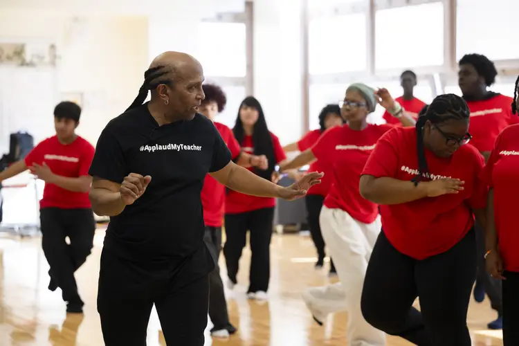 Tome Cousin teaches students a dance. 